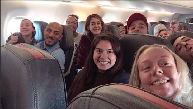 students on plane with professor