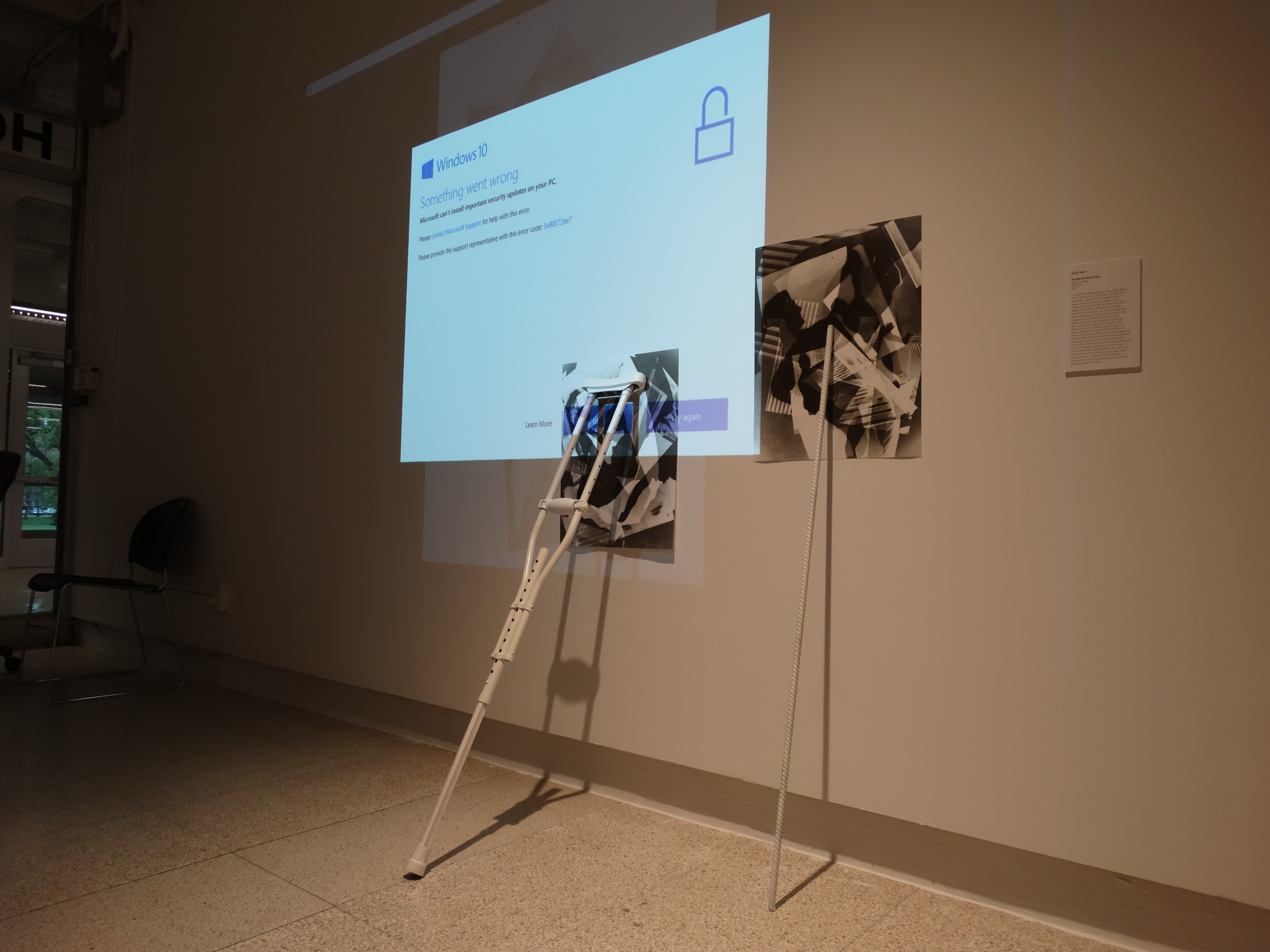 Projection on wall with crutch leaning against it