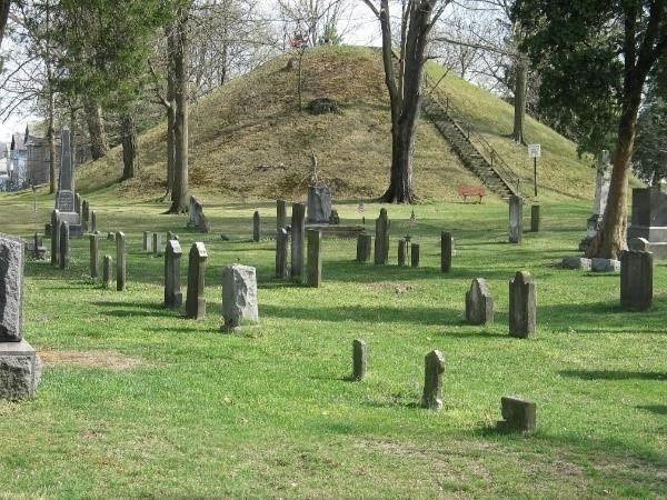 The Marietta Earthworks, a cemetery with a large grassy mound in the background