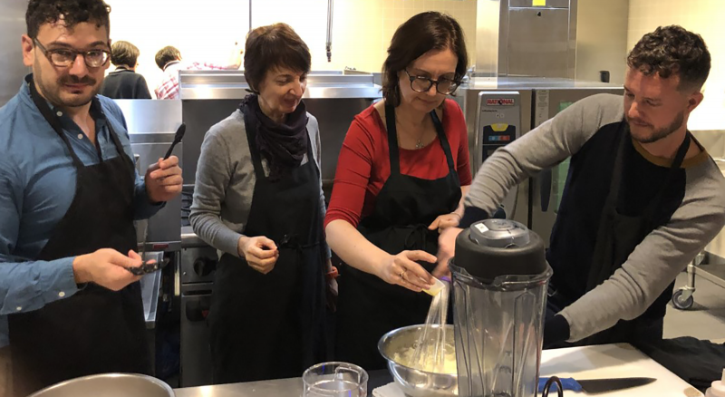 Photograph of attendees cooking meal