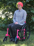 Smiling person in a wheelchair