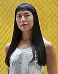 Woman in front of yellow background