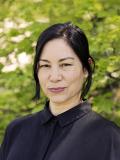 Smiling woman with dark hair and blouse
