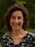 Smiling woman with brown hair and glasses