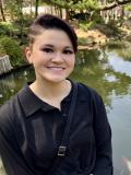 Smiling woman with short hair and dark shirt