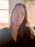 Woman with long hair and glasses