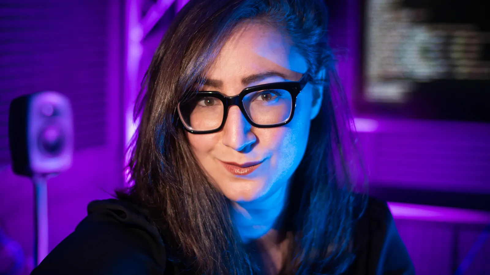 Serious woman with long hair and glasses