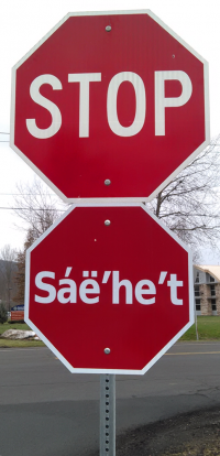 Photograph of stop signs in English and Seneca