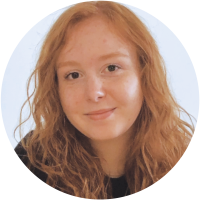 Smiling woman with long red hair and a dark shirt