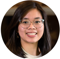 Smiling woman with glasses and long dark hair