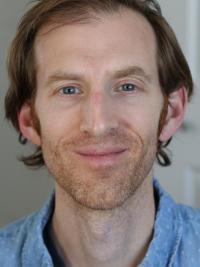 Smiling man wearing a blue dress shirt