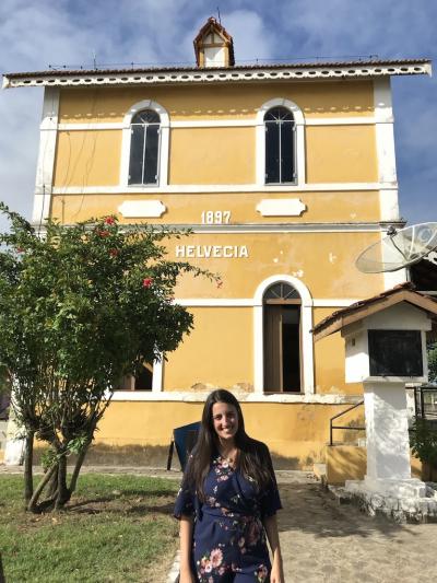 Luana in front of yellow building in Helvécia