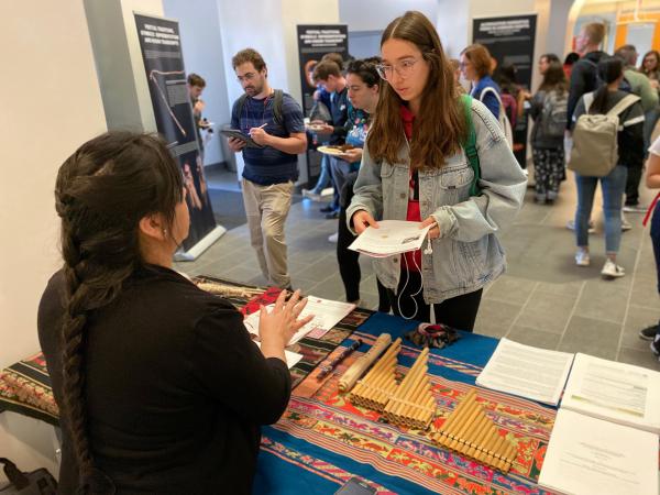 Photograph of student and faculty member discussing exhibit of artifacts