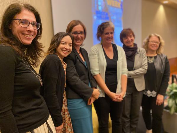 Photograph of Becca Heller with event organizers