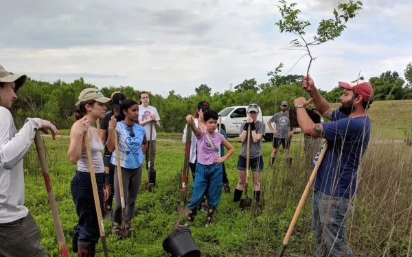 Field school students listen to planting instructions