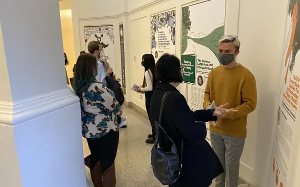 Attendees speaking with student fellows