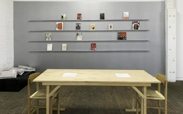 Photograph of artwork displayed on walls and tabletops