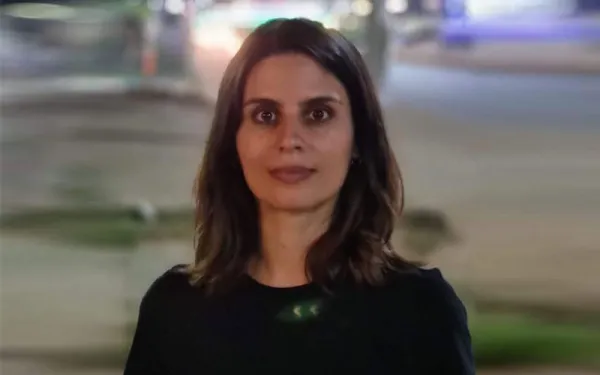 Serious woman in front of blurred streetscape
