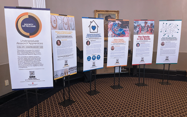 Six research posters mounted vertically in poster stands