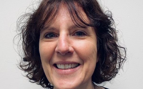 a smiling woman with short curly hair