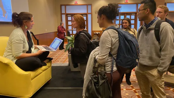 Becca Heller speaking with students