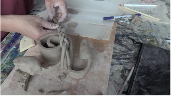 Ati Cachimuel and Ivan Ng (MFA student in the Art Department) work with clay.