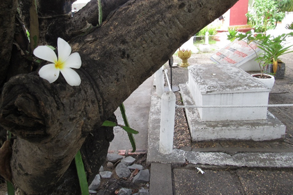 Fourteen unmarked graves rest in a garden outside of Tuol Sleng. They memorialize the victims who remain unknown.