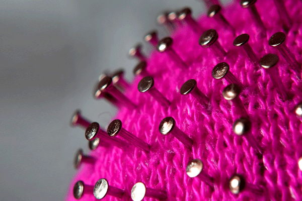 Artistic interpretation of COVID-19 molecule with yarn and nails