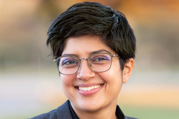 Smiling woman with short dark hair and glasses