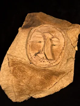 Leather artifact with a face on it