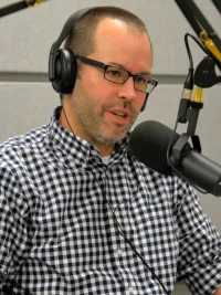 Man speaking into a microphone in a studio