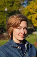 Woman in denim jacket outdoors in fall