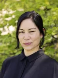Smiling woman with dark hair and blouse