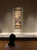 Woman looking at work of art