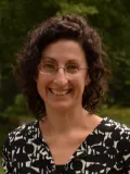 Smiling woman with brown hair and glasses