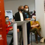 Speakers addressing crowd