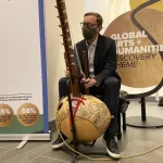 Musician playing an instrument called a kora