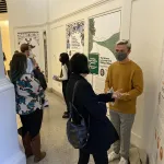 Attendees speaking with student fellows